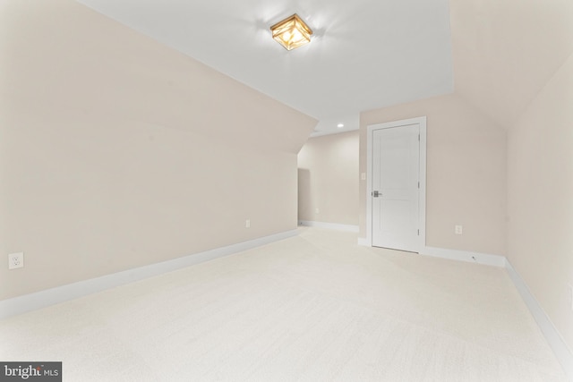 bonus room featuring lofted ceiling and light colored carpet