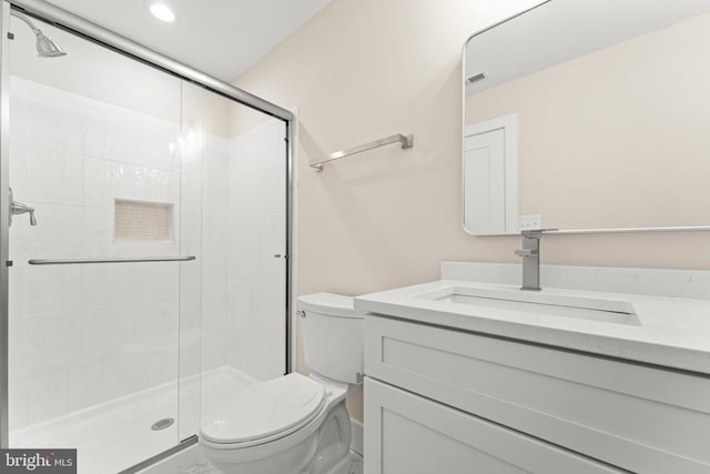 bathroom with vanity, toilet, and walk in shower