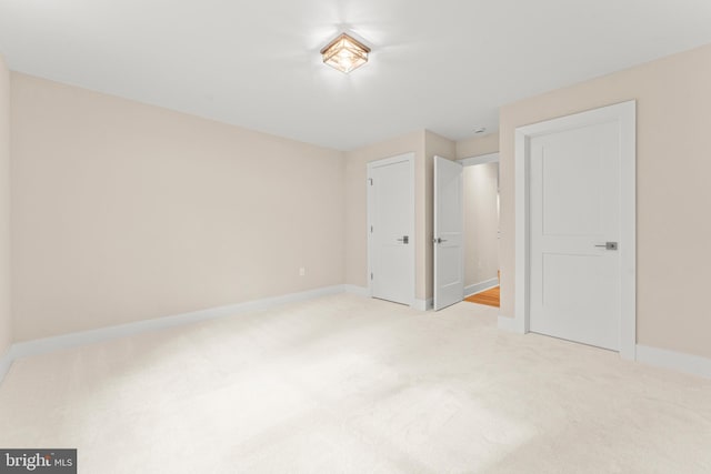 unfurnished bedroom featuring light carpet