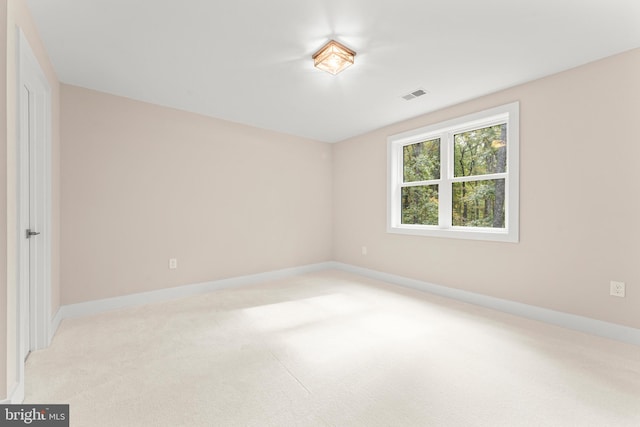 unfurnished room featuring light carpet