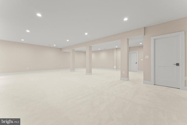 basement featuring light colored carpet