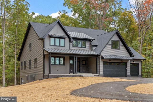 modern farmhouse style home with a garage, central air condition unit, and a porch