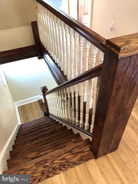 stairs with hardwood / wood-style flooring