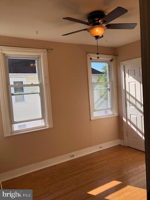 interior space with wood-type flooring and ceiling fan