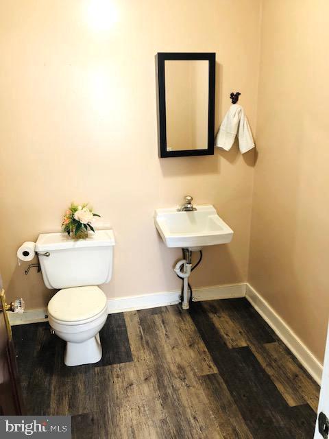 bathroom featuring hardwood / wood-style flooring, sink, and toilet