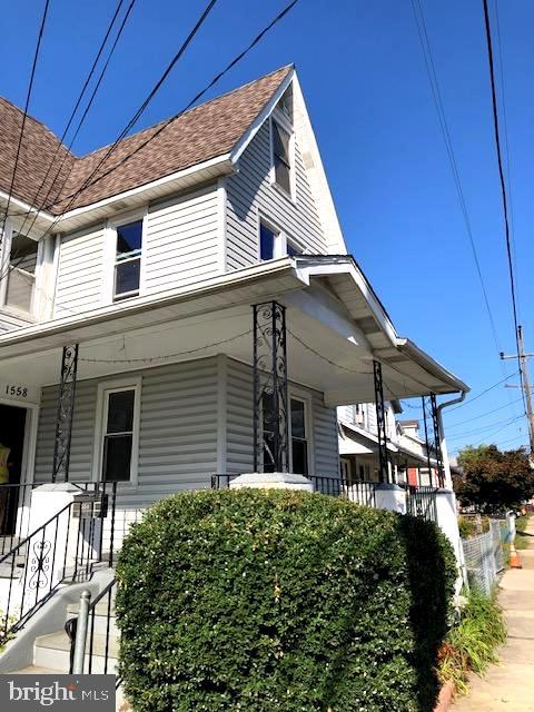 view of side of property with a porch