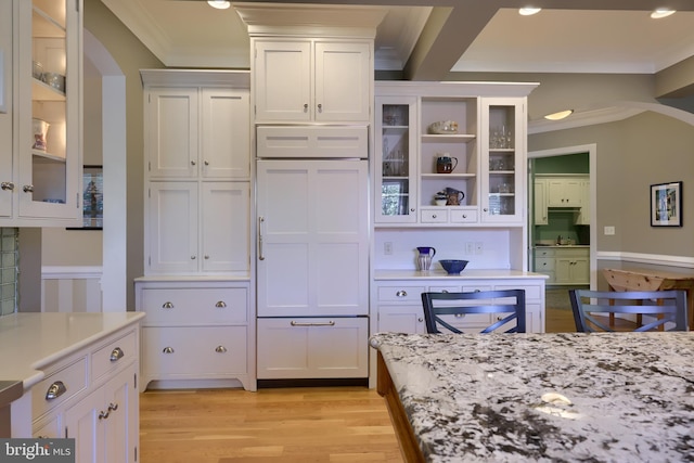 kitchen with ornamental molding, white cabinets, and light wood-style floors