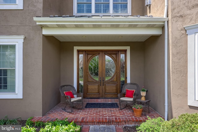 view of exterior entry featuring stucco siding
