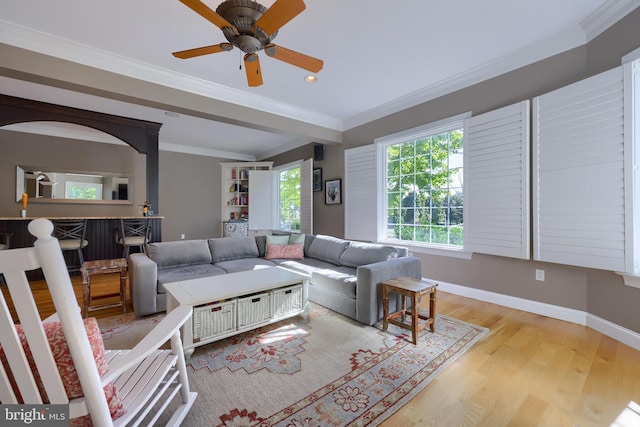 living area with recessed lighting, baseboards, ornamental molding, ceiling fan, and wood finished floors