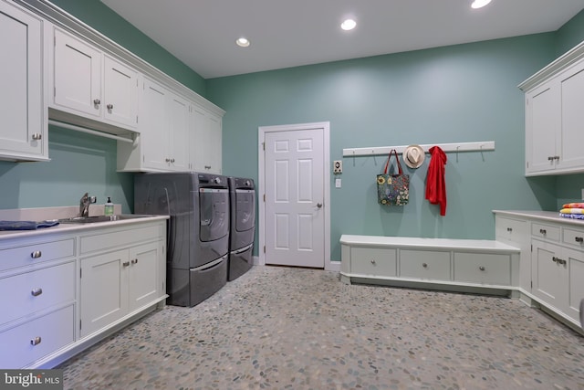 laundry area featuring recessed lighting, baseboards, washer and dryer, a sink, and cabinet space