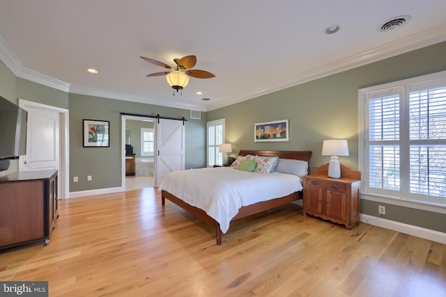 bedroom featuring ornamental molding, light wood finished floors, and visible vents