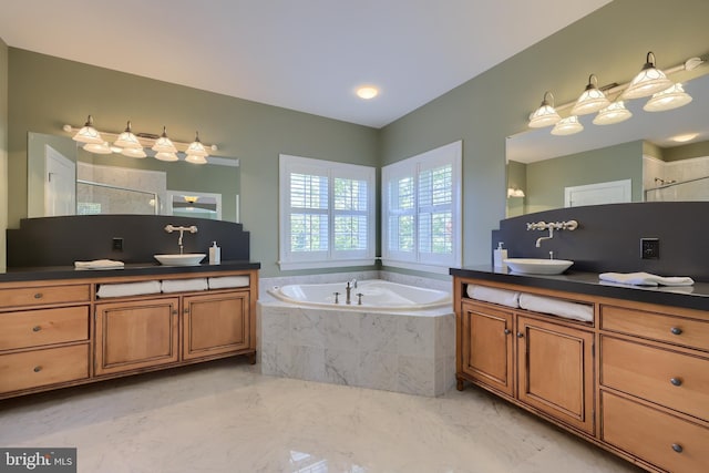 bathroom with a sink, two vanities, a bath, and a tile shower