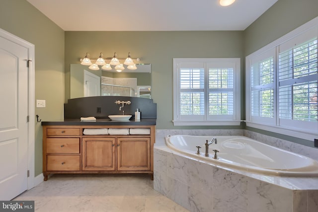 full bath with vanity, a bath, and a shower
