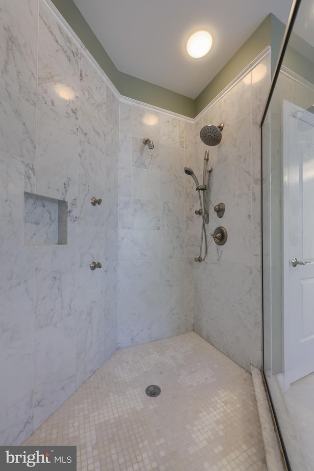 full bath featuring a tile shower