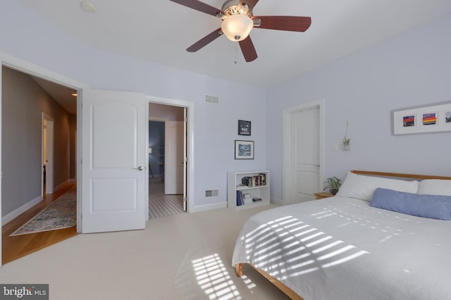 carpeted bedroom with ceiling fan, baseboards, and visible vents