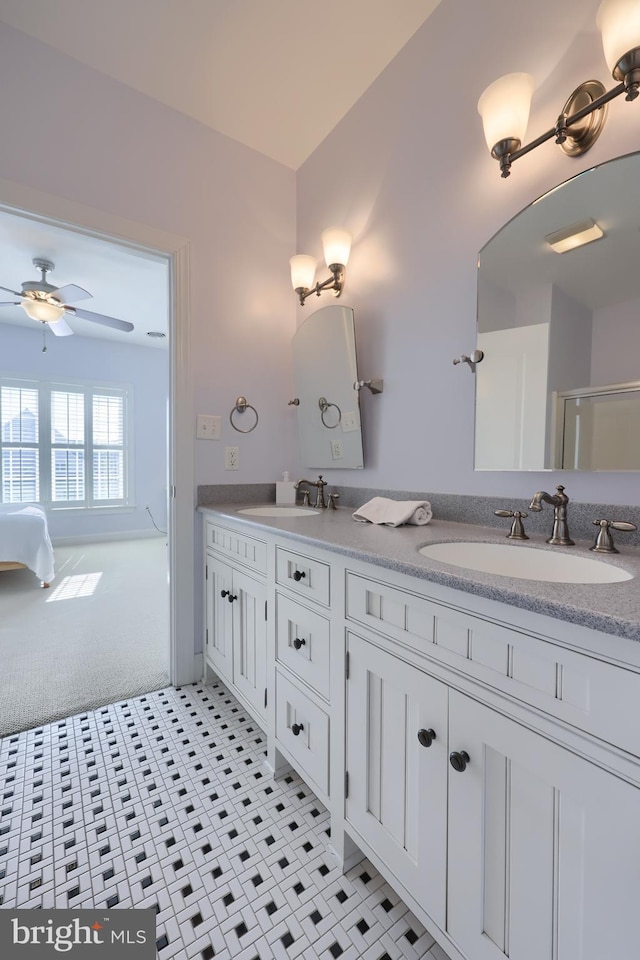 full bathroom featuring a sink, double vanity, ensuite bathroom, and ceiling fan