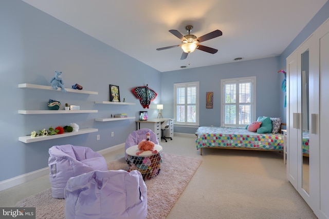 bedroom with baseboards, carpet flooring, and a ceiling fan