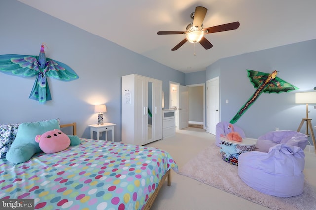 carpeted bedroom with a ceiling fan and baseboards
