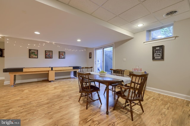 dining area with light wood-style flooring, baseboards, and visible vents