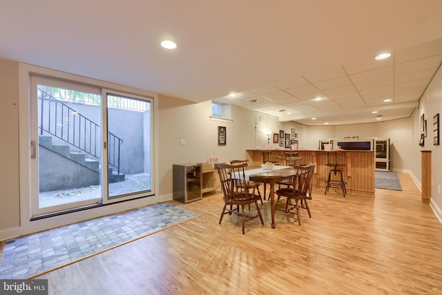 dining room with stairs, baseboards, light wood-type flooring, and recessed lighting