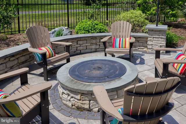 view of patio / terrace featuring a fire pit and fence