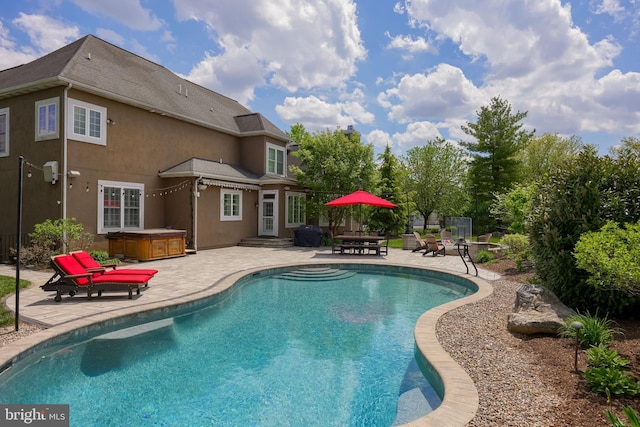 outdoor pool featuring entry steps, a patio, and a hot tub