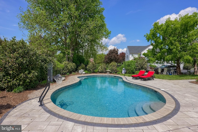 outdoor pool with a patio area