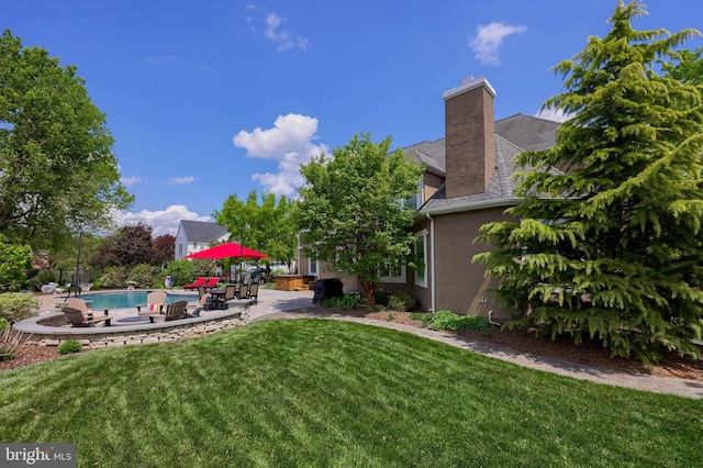 view of yard with a patio area and an outdoor pool