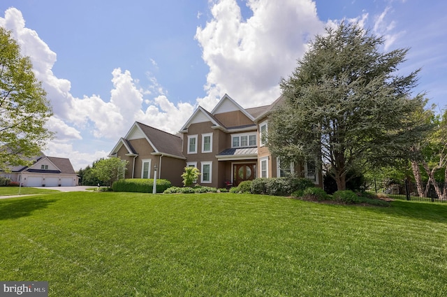 view of front of home featuring metal roof, a standing seam roof, stucco siding, and a front lawn