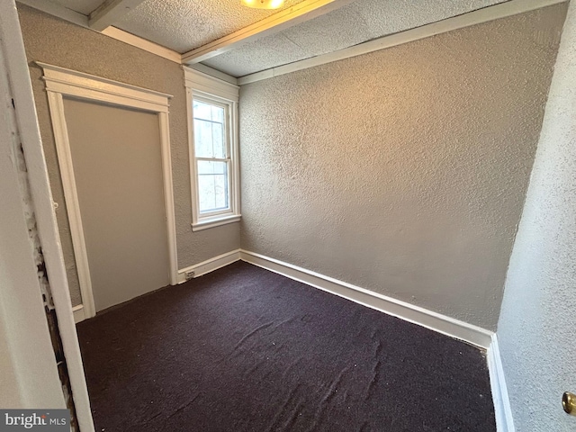 unfurnished bedroom featuring a textured ceiling and carpet flooring