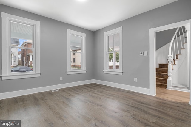 unfurnished room featuring dark hardwood / wood-style flooring