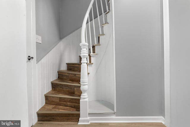 stairway with hardwood / wood-style flooring