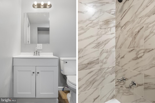 bathroom featuring vanity, tiled shower, and toilet