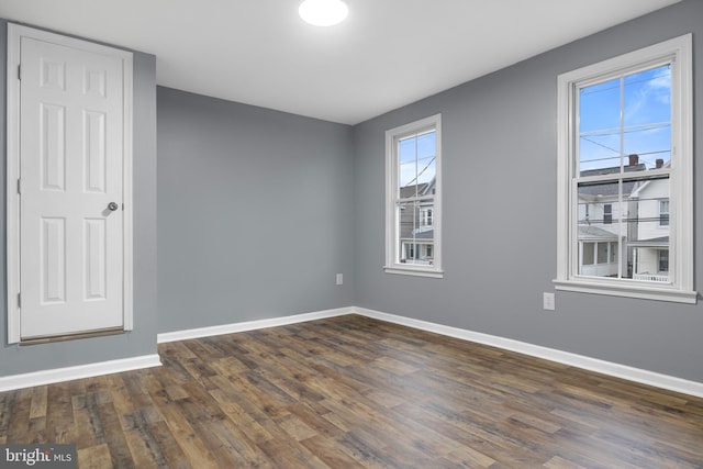 spare room with dark wood-type flooring