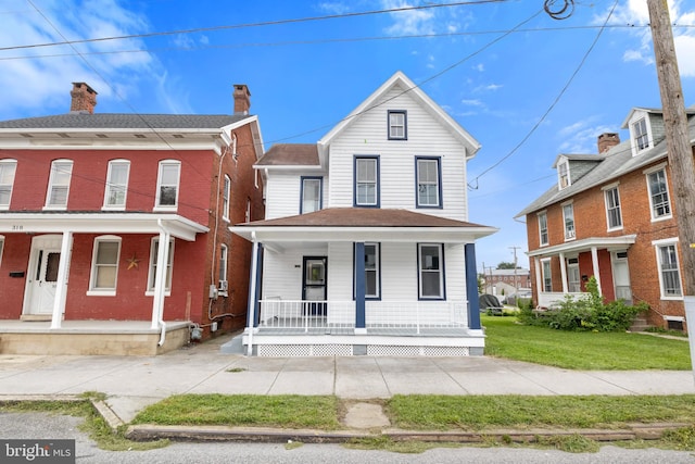 view of front of property with a porch and a front lawn