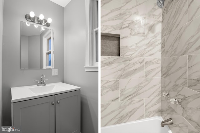 bathroom with vanity and tiled shower / bath combo