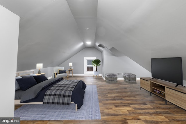 bedroom with vaulted ceiling and dark hardwood / wood-style floors