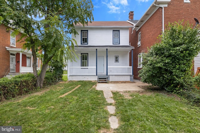 view of property featuring a front yard and a porch