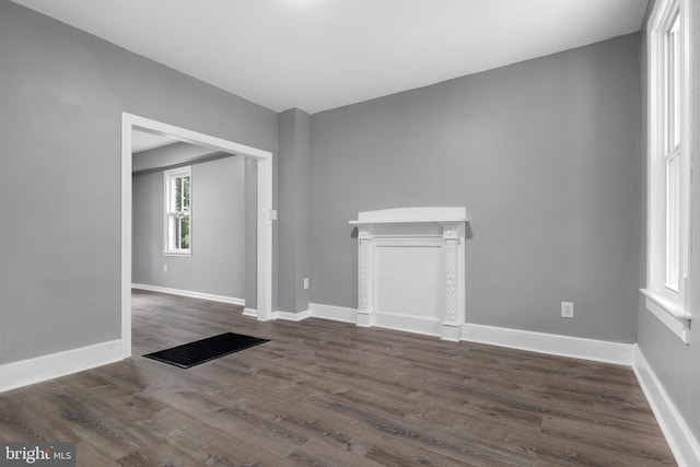 unfurnished living room featuring dark hardwood / wood-style floors