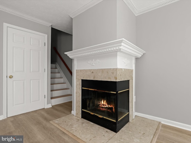 room details with a textured ceiling, crown molding, and hardwood / wood-style floors