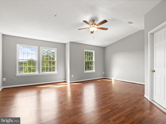 unfurnished room featuring ceiling fan, a textured ceiling, lofted ceiling, and dark hardwood / wood-style floors