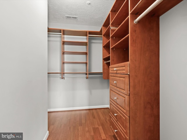 walk in closet featuring hardwood / wood-style floors