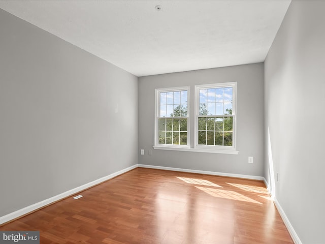 empty room with light hardwood / wood-style flooring