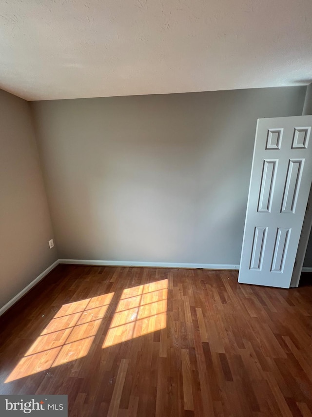 spare room with hardwood / wood-style flooring