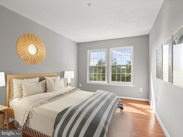 bedroom with hardwood / wood-style flooring