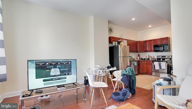 kitchen with appliances with stainless steel finishes and light hardwood / wood-style flooring