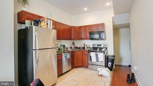 kitchen featuring appliances with stainless steel finishes and light hardwood / wood-style flooring