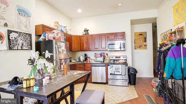 kitchen featuring appliances with stainless steel finishes and light hardwood / wood-style floors