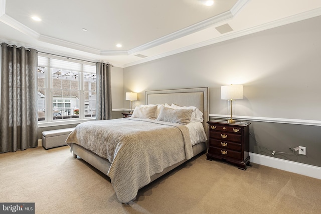 carpeted bedroom with a raised ceiling and ornamental molding