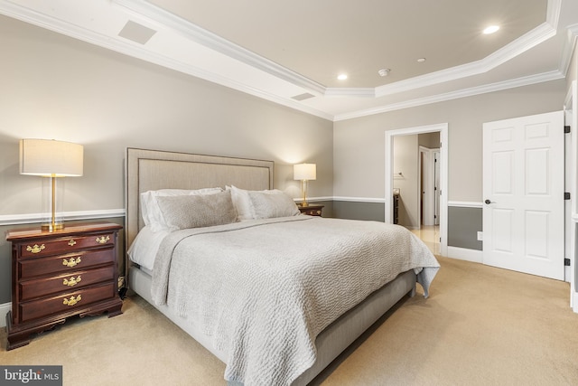 bedroom with crown molding, a raised ceiling, and light carpet